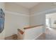 Bright hallway with carpeted floors, white trim, and a view into a sunlit bedroom with access to a balcony at 482 Sea Cloud Cir, Edisto Island, SC 29438