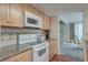 The kitchen features updated countertops, bright cabinetry and appliances, plus an open view of the dining area at 482 Sea Cloud Cir, Edisto Island, SC 29438