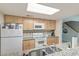 Kitchen boasts bright cabinets, granite countertops, and modern appliances, including a microwave and electric range at 482 Sea Cloud Cir, Edisto Island, SC 29438
