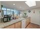 Kitchen features a breakfast bar, stainless steel sink, light countertops, and views to the dining area at 482 Sea Cloud Cir, Edisto Island, SC 29438