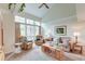 Bright living room with vaulted ceiling, neutral carpeting, comfortable seating, and a large window with a view at 482 Sea Cloud Cir, Edisto Island, SC 29438