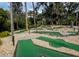 Fun mini-golf course with green turf, stone paths, and mature trees for shade and recreation at 482 Sea Cloud Cir, Edisto Island, SC 29438