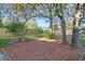 Scenic backyard featuring mature trees, well maintained lawn and fenced perimeter at 502 W Ashley Ave, Folly Beach, SC 29439