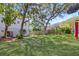 Lush backyard with mature trees and green lawn, perfect for outdoor activities and relaxation at 502 W Ashley Ave, Folly Beach, SC 29439