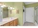 Bathroom featuring a double vanity, framed mirror, and tile flooring at 502 W Ashley Ave, Folly Beach, SC 29439