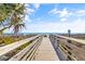 Boardwalk leading to a sunny beach with waves at 502 W Ashley Ave, Folly Beach, SC 29439