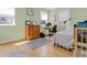 Bright bedroom with a wooden dresser, a desk, and a bed with striped bedding near windows at 502 W Ashley Ave, Folly Beach, SC 29439