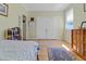 Bright bedroom with a large double door closet and a blue patterned rug on the hardwood floor at 502 W Ashley Ave, Folly Beach, SC 29439
