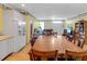 Open-concept dining and living room with white cabinets and hardwood floors at 502 W Ashley Ave, Folly Beach, SC 29439