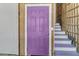 Striking purple door leading to the stairwell, adding a pop of color and personality to the home's entry at 502 W Ashley Ave, Folly Beach, SC 29439