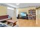 Well-lit living room with hardwood floors and a cozy futon at 502 W Ashley Ave, Folly Beach, SC 29439