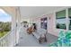 Inviting covered porch area with seating and grilling space, perfect for outdoor relaxation and entertaining with ocean views at 502 W Ashley Ave, Folly Beach, SC 29439