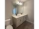 This bathroom includes a double sink vanity with modern fixtures and luxury vinyl flooring at 5126 Double Eagle, Summerville, SC 29485