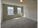 A bright bedroom is carpeted and features two windows that let in plenty of natural light at 5126 Double Eagle, Summerville, SC 29485