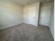 A standard sized bedroom with neutral carpet and white doors leading to closet and bath at 5126 Double Eagle, Summerville, SC 29485