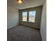 A well-lit carpeted bedroom featuring two windows at 5126 Double Eagle, Summerville, SC 29485
