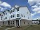 View of three-story townhouse with siding, brick facade and new construction at 5126 Double Eagle, Summerville, SC 29485