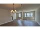 Modern living room featuring a stylish chandelier and large windows at 5126 Double Eagle, Summerville, SC 29485