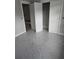 Bedroom includes gray carpet, white trim, and features three doors at 6201 Drayton St, Ravenel, SC 29470