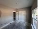 Bright bedroom featuring smooth walls, trim, closet, and modern lighting fixtures creating a serene and inviting space at 6201 Drayton St, Ravenel, SC 29470