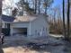 New construction home featuring a garage, level yard, and modern design nestled in a scenic, wooded setting at 6201 Drayton St, Ravenel, SC 29470