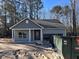 New construction home featuring sage green siding, a garage, and a well-manicured front yard in a peaceful neighborhood at 6201 Drayton St, Ravenel, SC 29470