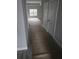 View of the long hallway with white doors leading into the living room at 6201 Drayton St, Ravenel, SC 29470