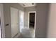 Hallway featuring smooth walls and bright lighting with clear views into adjacent rooms at 6201 Drayton St, Ravenel, SC 29470