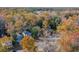 An aerial view of a residential area surrounded by a dense canopy of trees in their autumn colors at 635 Fair Spring Dr, Charleston, SC 29414