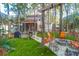 Lush backyard with a firepit, swing chairs, artificial grass and a view of the home at 635 Fair Spring Dr, Charleston, SC 29414