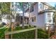 Back of the home, with the porch, sitting among artificial grass, surrounded by beautiful landscaping at 635 Fair Spring Dr, Charleston, SC 29414