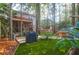 Beautiful backyard featuring artificial grass, lush foliage, a grill, and the home with a screened in porch at 635 Fair Spring Dr, Charleston, SC 29414