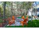 Inviting backyard with a stone fire pit area, Adirondack chairs, and a well-manicured lawn at 635 Fair Spring Dr, Charleston, SC 29414