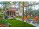 Inviting backyard featuring a fire pit, mature trees, and outdoor seating perfect for relaxing or entertaining at 635 Fair Spring Dr, Charleston, SC 29414