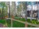 Fenced backyard with artificial grass, trees and a view of the screened in porch on the back of the home at 635 Fair Spring Dr, Charleston, SC 29414