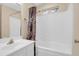 Bright bathroom with a white shower and tile, decorative shower curtain, and accent stained glass window at 635 Fair Spring Dr, Charleston, SC 29414