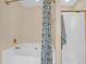 A bathroom featuring a luxurious soaking tub and a separate shower area with a patterned shower curtain at 635 Fair Spring Dr, Charleston, SC 29414