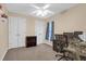 Cozy bedroom with neutral walls, carpet, double closets, a ceiling fan, and a desk with computer at 635 Fair Spring Dr, Charleston, SC 29414