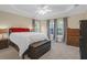 Spacious bedroom with neutral carpeting, a tray ceiling, and three large windows at 635 Fair Spring Dr, Charleston, SC 29414