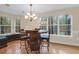Charming dining area with a barrel table, custom chairs, and natural light from the surrounding windows at 635 Fair Spring Dr, Charleston, SC 29414