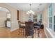 Bright dining room with hardwood floors, a chandelier, and windows offering views of the outdoors at 635 Fair Spring Dr, Charleston, SC 29414