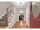 Inviting foyer with hardwood floors, a staircase, and an arched entrance to the living room at 635 Fair Spring Dr, Charleston, SC 29414