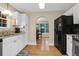 Bright kitchen with white cabinets, stainless steel appliances, and an archway leading to the dining area at 635 Fair Spring Dr, Charleston, SC 29414