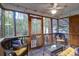 Relaxing screened porch featuring a ceiling fan, string lights, and wicker furniture, perfect for enjoying the outdoors at 635 Fair Spring Dr, Charleston, SC 29414