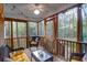 Relaxing screened porch featuring a ceiling fan, string lights, and wicker furniture, perfect for enjoying the outdoors at 635 Fair Spring Dr, Charleston, SC 29414
