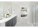 Bathroom featuring a double sink vanity, white countertops, and a glass-enclosed shower at 743 Meadowbrook Ln, Summerville, SC 29486
