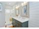 Elegant bathroom with double vanity, wood-look framed mirrors, and walk-in glass shower at 744 Gate Post Dr, Mount Pleasant, SC 29464