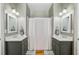 Well-lit bathroom with double sinks, modern fixtures, and a shower-tub combination at 744 Gate Post Dr, Mount Pleasant, SC 29464