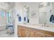 Bright bathroom with double vanity, framed mirrors, and shiplap accent walls at 744 Gate Post Dr, Mount Pleasant, SC 29464