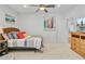 Light-filled bedroom boasting neutral carpet, woven headboard, and colorful surf art at 744 Gate Post Dr, Mount Pleasant, SC 29464